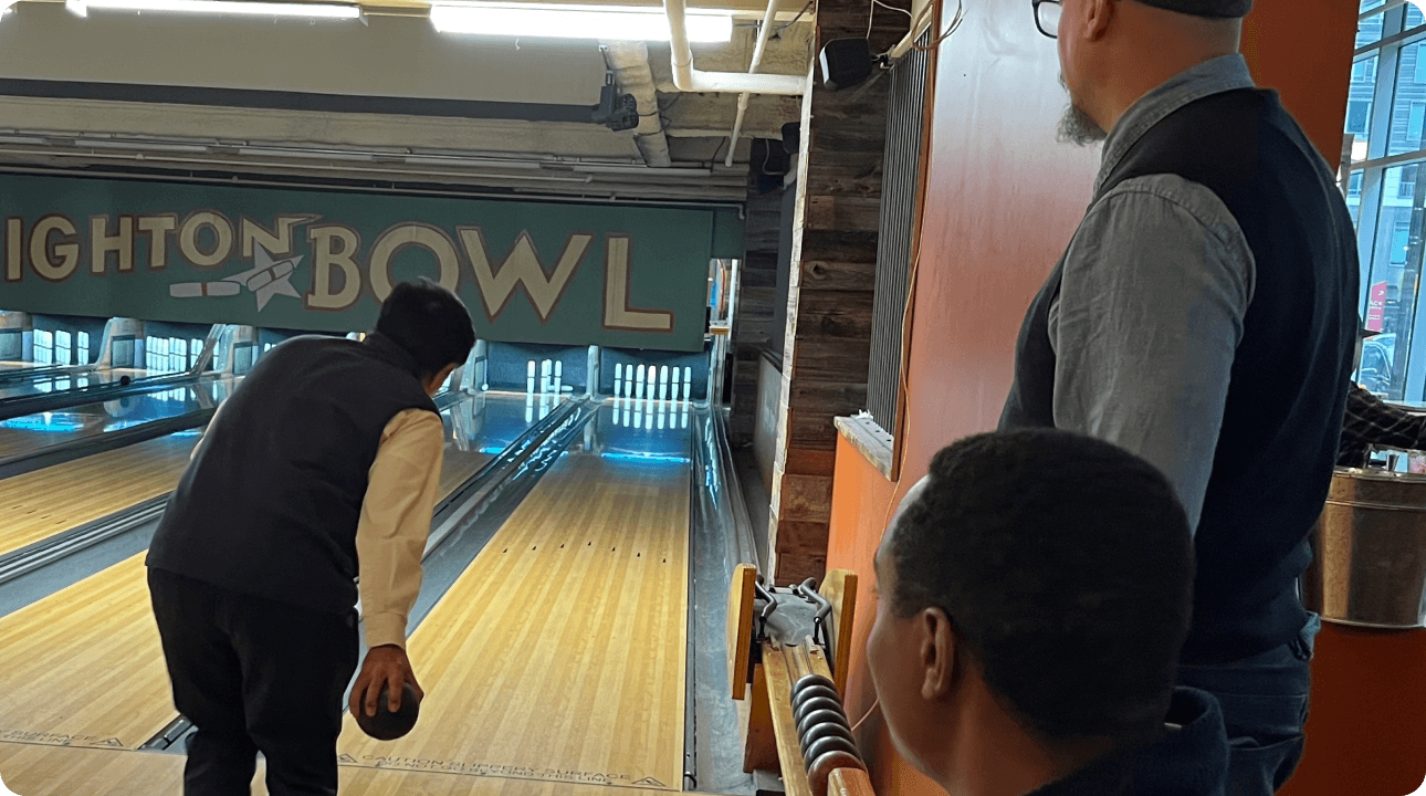 picture of the LEAF team talking at bowling alley